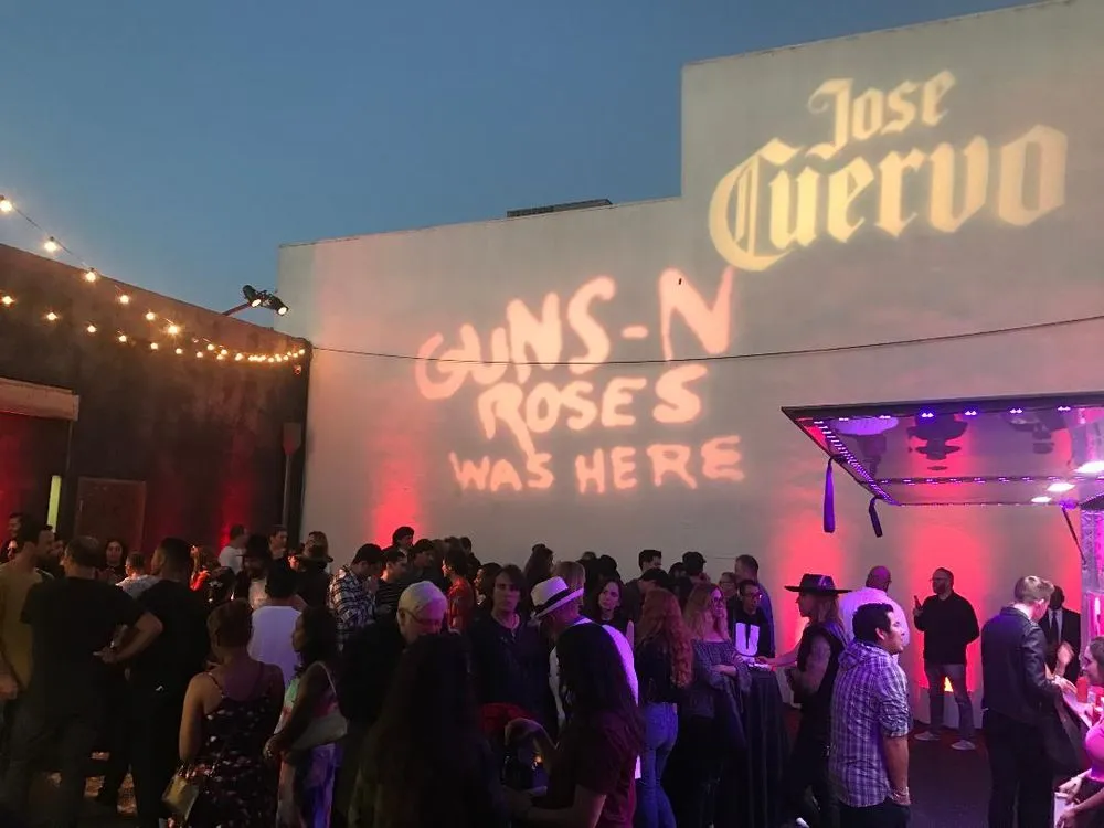 Brand logos projected in light at an outdoor corporate event in Los Angeles