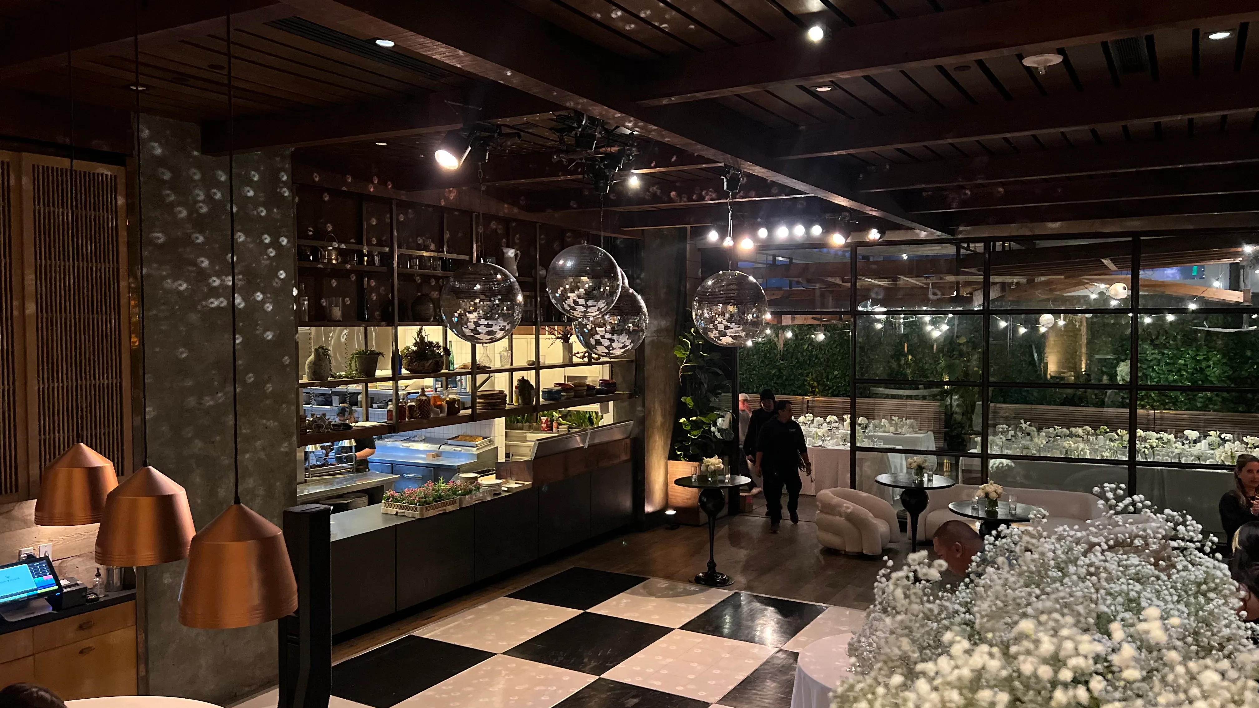 Restaurant interior dressed for a party with mirror balls and a checkered dance floor